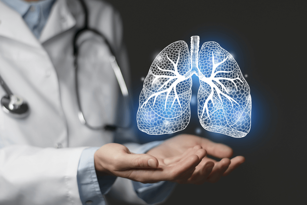 Physician holding a rendering of the lungs on a black background