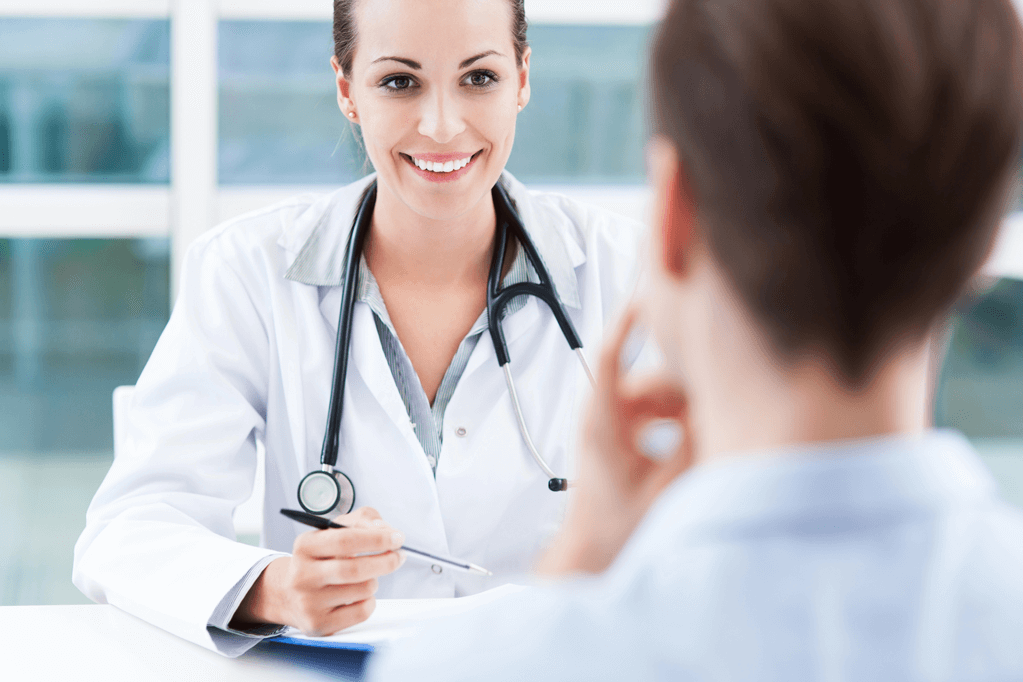 Physician at a desk meeting with a Patient