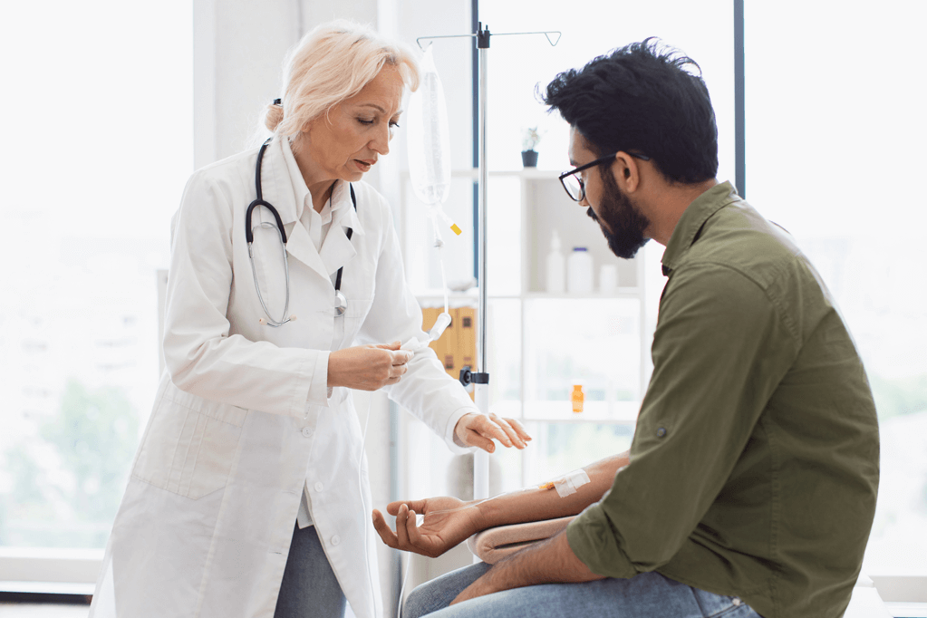 Physician and Patient with infusion therapy at a clinic