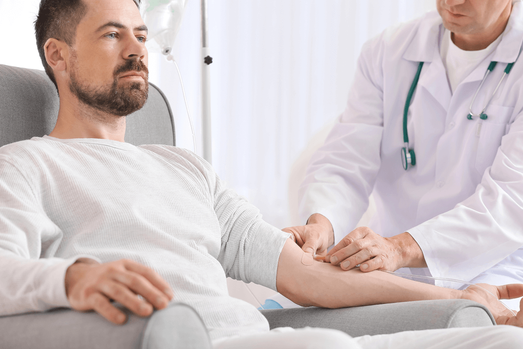Patient in an infusion chair receiving infusion therapy for psoriatic arthritis